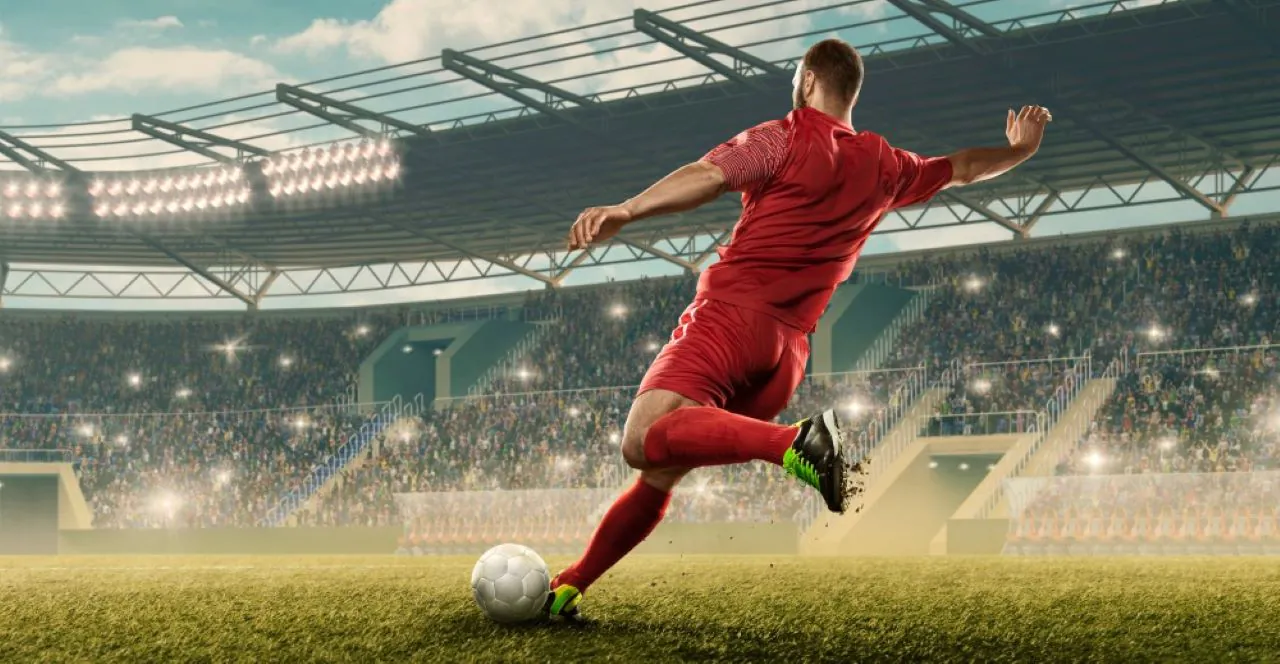 A soccer player kicks the ball